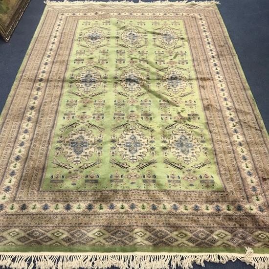 A Persian style green ground carpet 275 x 185cm